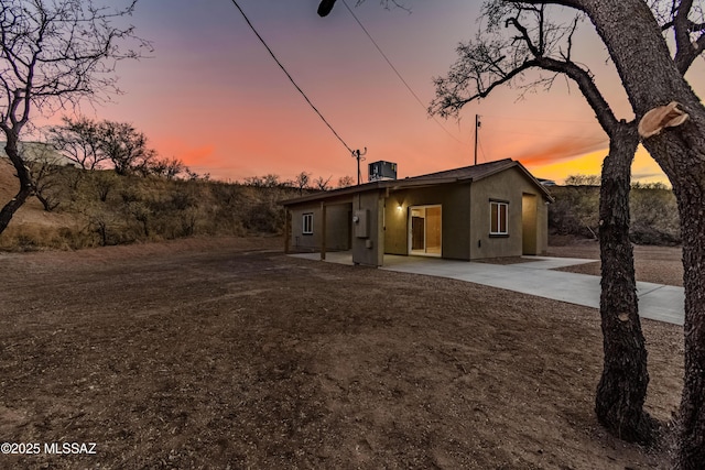 view of front of house featuring cooling unit and a patio area