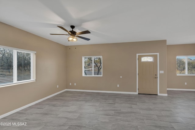 foyer entrance featuring ceiling fan