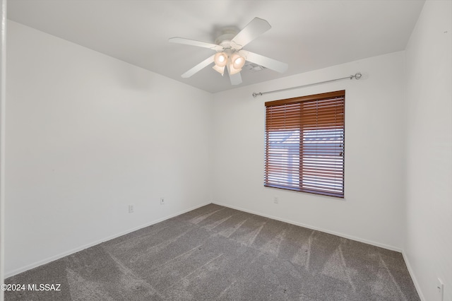 spare room with ceiling fan and carpet