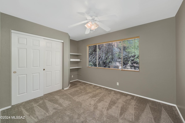 unfurnished bedroom with carpet flooring, a closet, and ceiling fan