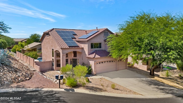 view of front of property featuring solar panels and a garage