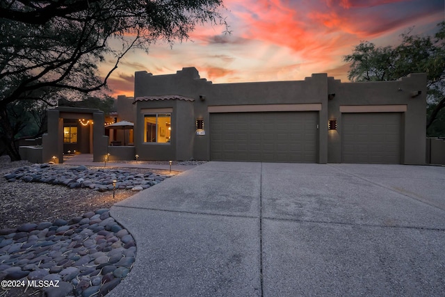 pueblo-style house with a garage