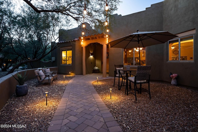 rear view of property with a patio area and a pergola