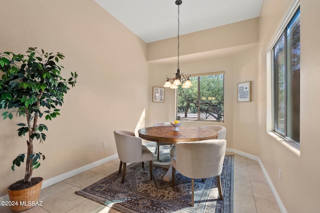 tiled dining room featuring a chandelier