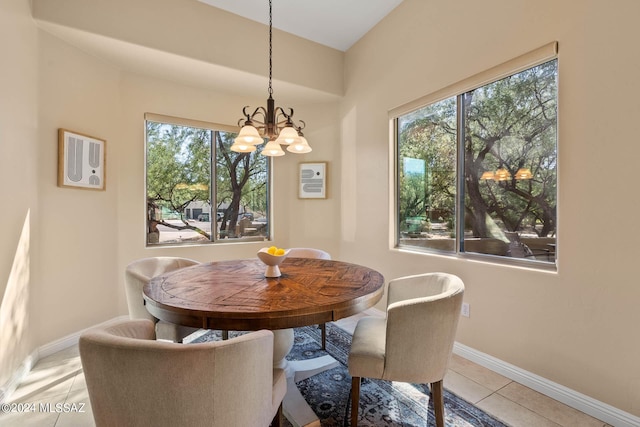 dining room with a wealth of natural light, baseboards, a chandelier, and light tile patterned floors