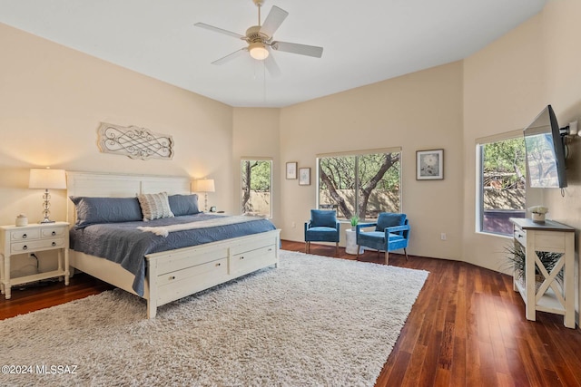 bedroom with dark wood-type flooring, multiple windows, and a ceiling fan