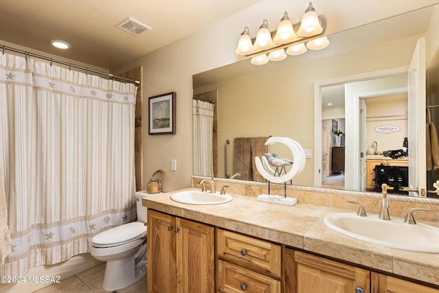 bathroom with tile patterned flooring, vanity, and toilet