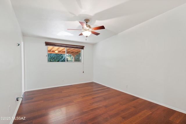 spare room featuring a ceiling fan, baseboards, and wood-type flooring