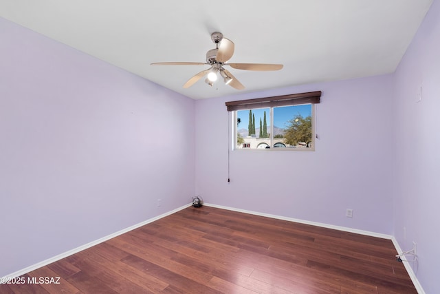 unfurnished room featuring dark wood-type flooring and ceiling fan