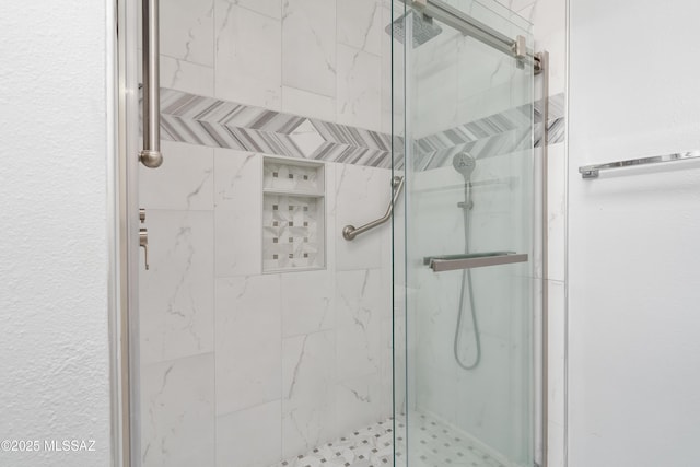 full bathroom with a marble finish shower