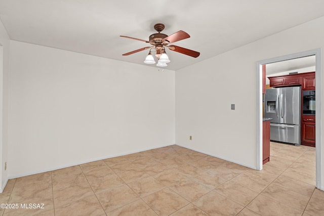 tiled spare room featuring ceiling fan