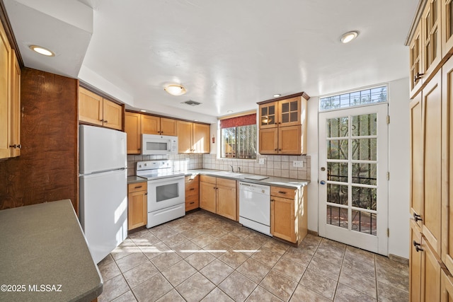 kitchen featuring white appliances, sink, decorative backsplash, and light tile patterned floors