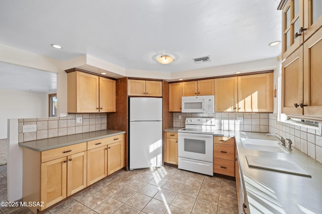 kitchen with sink, white appliances, backsplash, and light tile patterned flooring