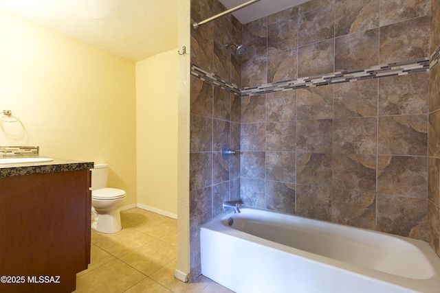 full bathroom with tile patterned floors, vanity, tiled shower / bath combo, and toilet