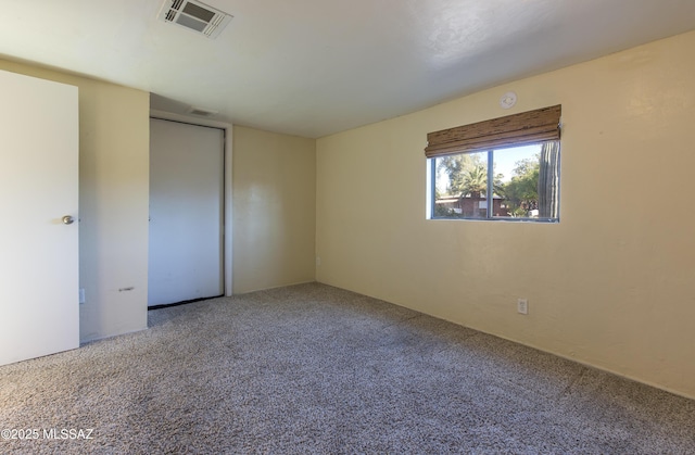 unfurnished bedroom with carpet floors and a closet