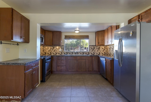 kitchen featuring decorative backsplash, stainless steel appliances, light tile patterned flooring, and sink