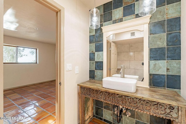 bathroom featuring sink, tile walls, and tile patterned flooring