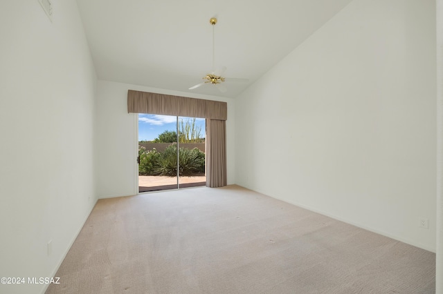 empty room with light carpet, vaulted ceiling, and ceiling fan