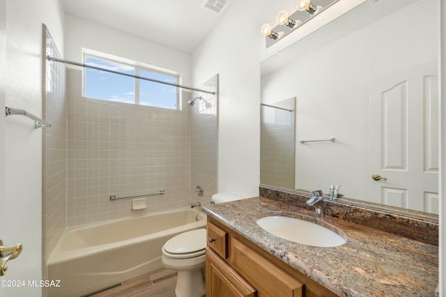 full bathroom with wood-type flooring, vanity, toilet, and tiled shower / bath