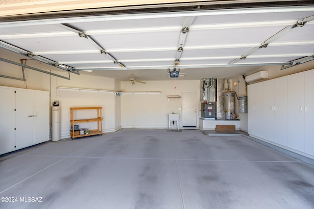 garage featuring heating unit, water heater, and a garage door opener