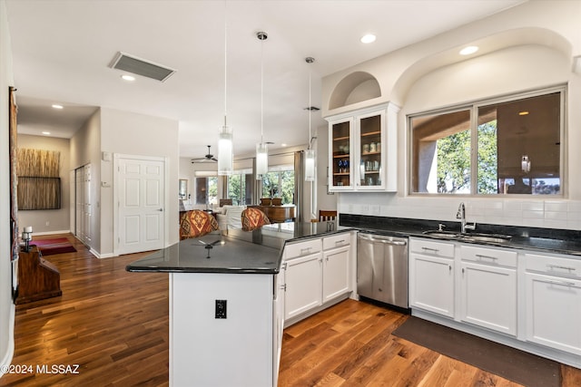 kitchen featuring dishwasher, white cabinets, sink, hanging light fixtures, and kitchen peninsula