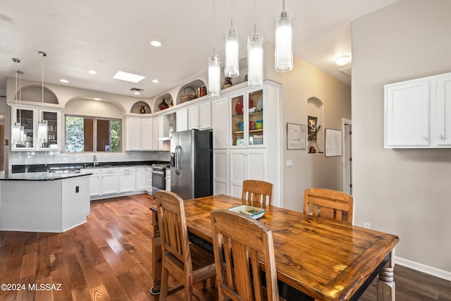 dining space featuring dark hardwood / wood-style flooring and sink