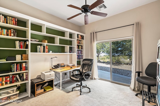 carpeted office space featuring ceiling fan