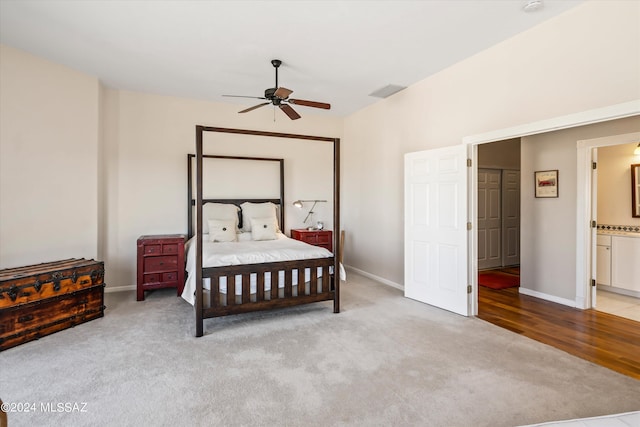 carpeted bedroom with ceiling fan and ensuite bathroom