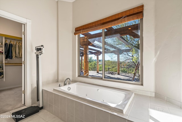 bathroom with tile patterned floors and tiled bath