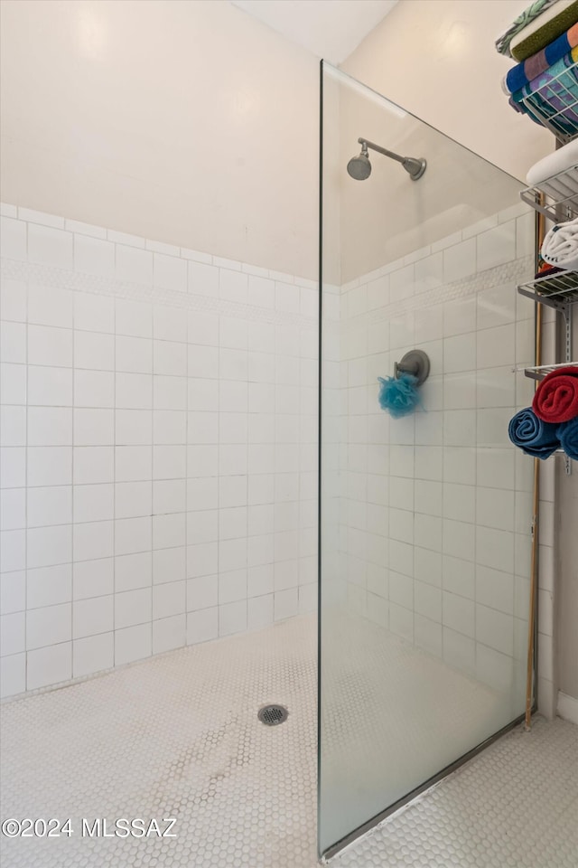 bathroom with tile patterned flooring and tiled shower