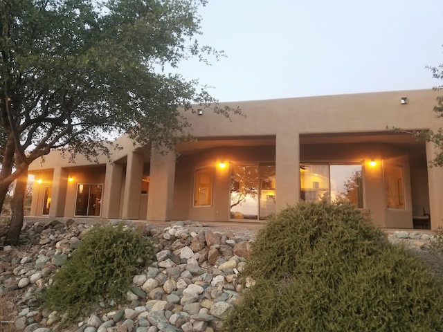 view of back house at dusk