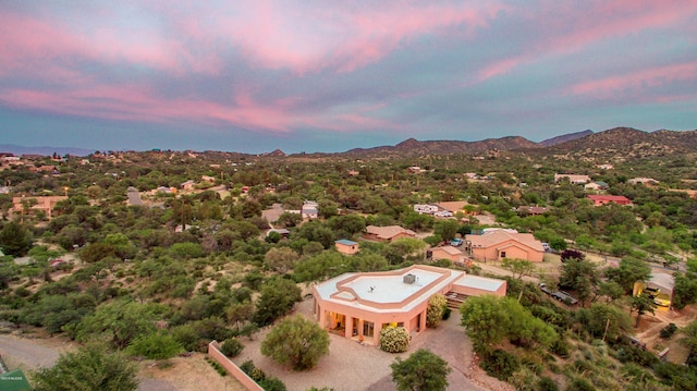 aerial view at dusk featuring a mountain view