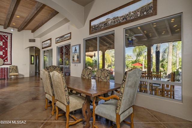 tiled dining space featuring wood ceiling and beamed ceiling