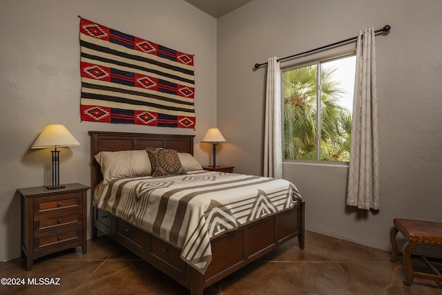 bedroom with dark tile patterned floors