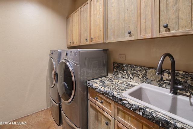 laundry room featuring cabinets, sink, separate washer and dryer, and light tile patterned flooring