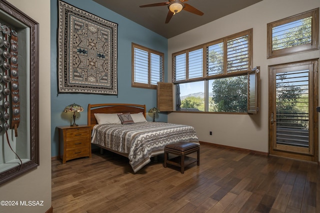 bedroom with vaulted ceiling, ceiling fan, and dark hardwood / wood-style flooring