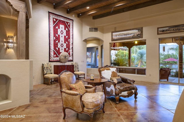 sitting room featuring beamed ceiling and wood ceiling