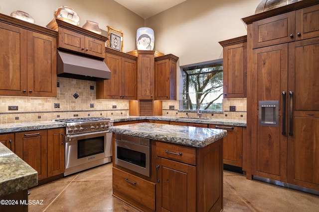 kitchen with exhaust hood, decorative backsplash, light stone countertops, stainless steel appliances, and light tile patterned floors