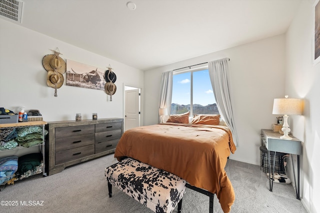 bedroom featuring light colored carpet and visible vents