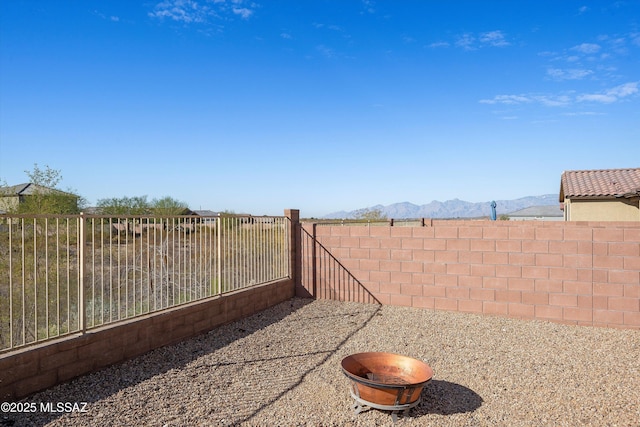 view of yard featuring a fenced backyard and a mountain view