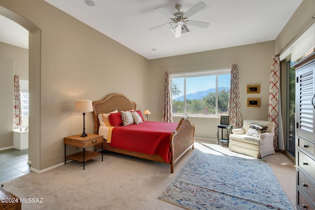 bedroom featuring ceiling fan, a mountain view, and light carpet