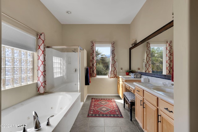 bathroom featuring tile patterned flooring, vanity, plus walk in shower, and a healthy amount of sunlight