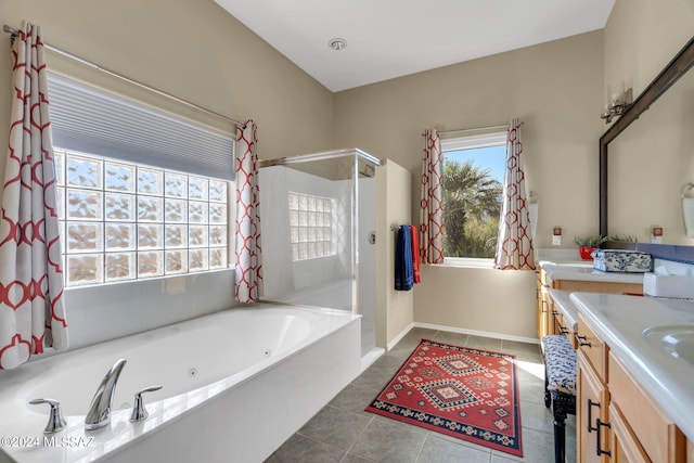 bathroom with tile patterned floors, vanity, shower with separate bathtub, and a wealth of natural light