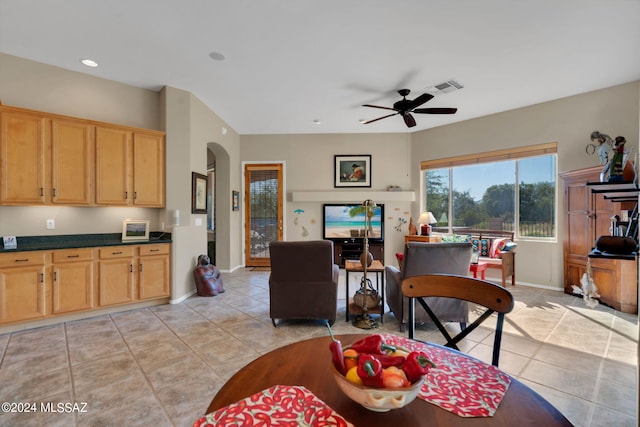 tiled dining area with ceiling fan