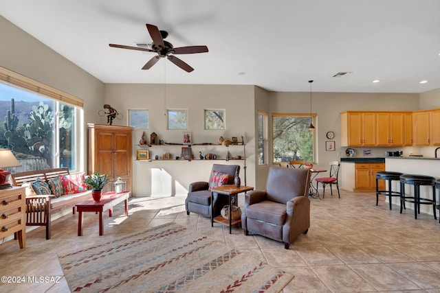 tiled living room with ceiling fan and plenty of natural light