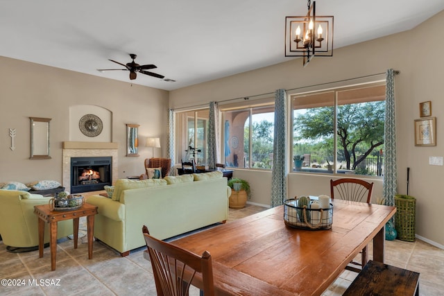 dining room featuring ceiling fan with notable chandelier and light tile patterned floors