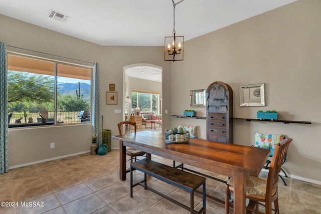 dining space featuring an inviting chandelier and light tile patterned flooring