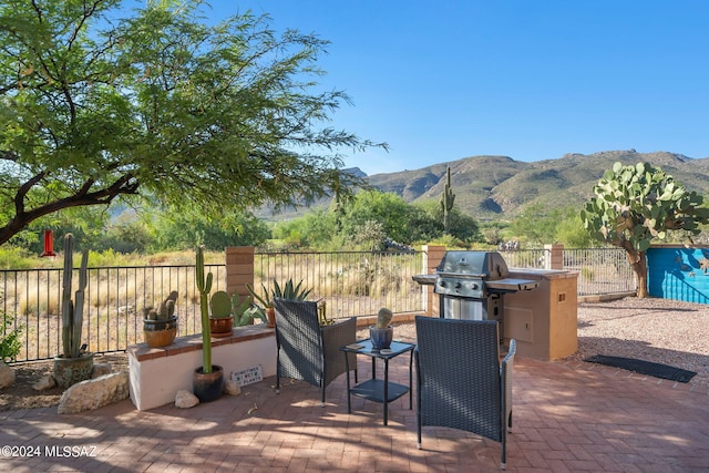 view of patio / terrace with a grill and a mountain view