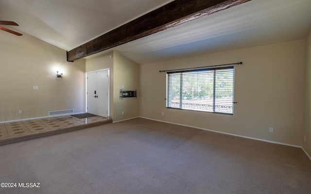 carpeted spare room with beamed ceiling and ceiling fan