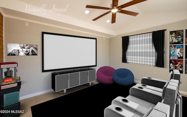 tiled cinema room featuring ceiling fan and lofted ceiling